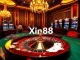 Experience the excitement of Xin88 with a luxurious casino scene featuring dynamic gaming tables and thrilling slot machines.